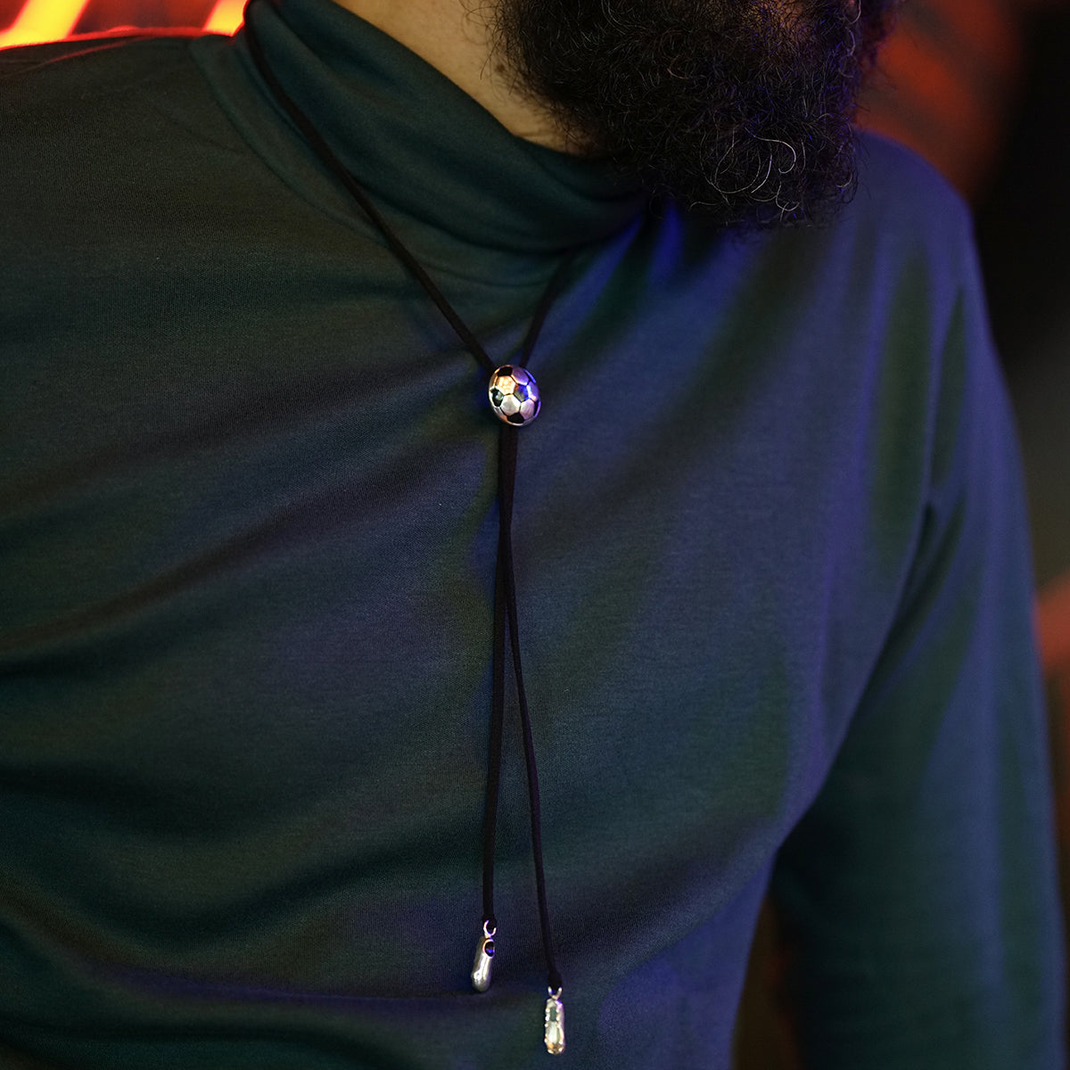 a man with a beard wearing a necklace