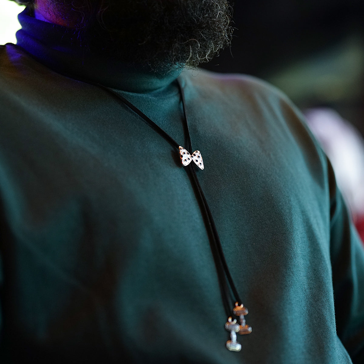 a close up of a person wearing a necklace
