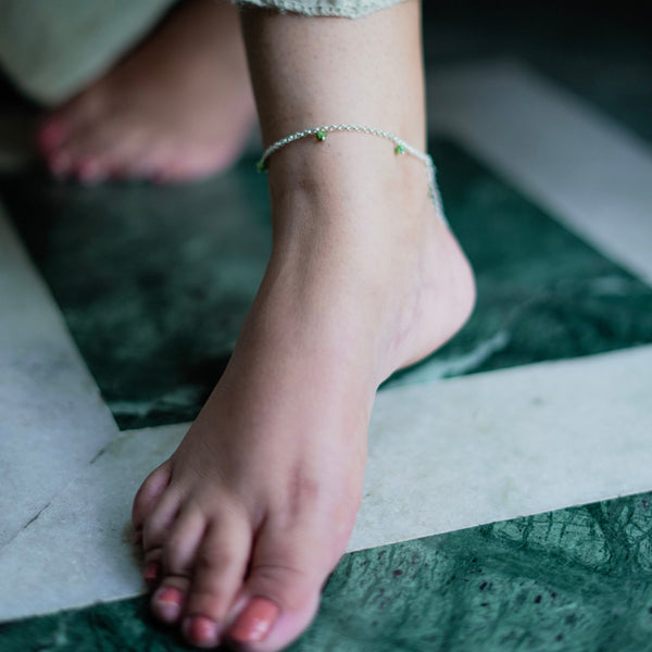 Close-up of silver anklet on ankle