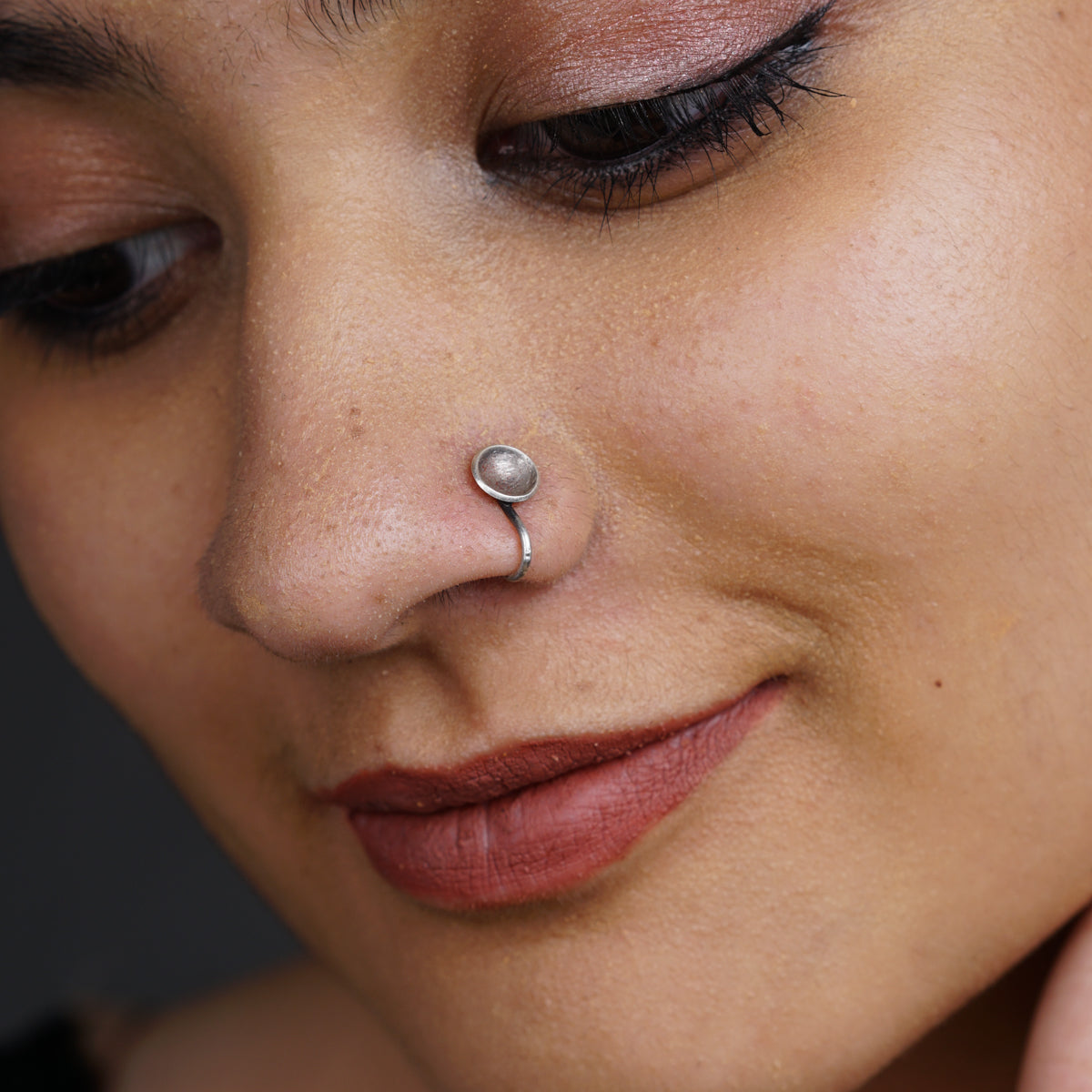 a woman with a nose piercing on her nose