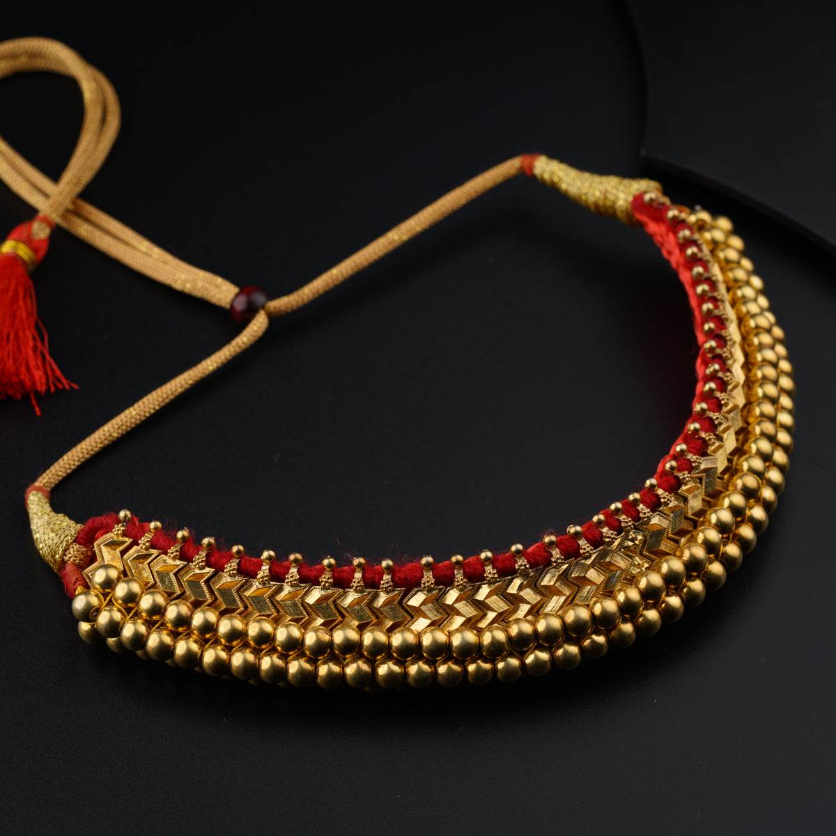 a close up of a necklace on a black surface