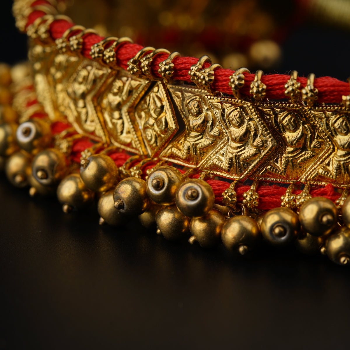 a close up of a gold bracelet on a table