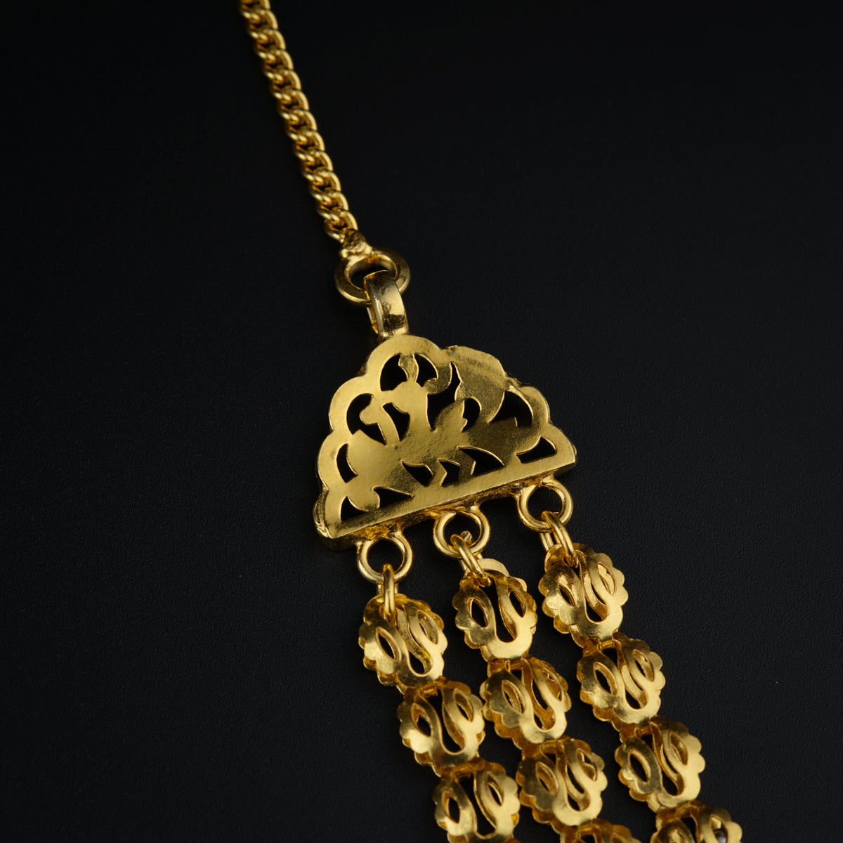 a gold necklace with a heart on it