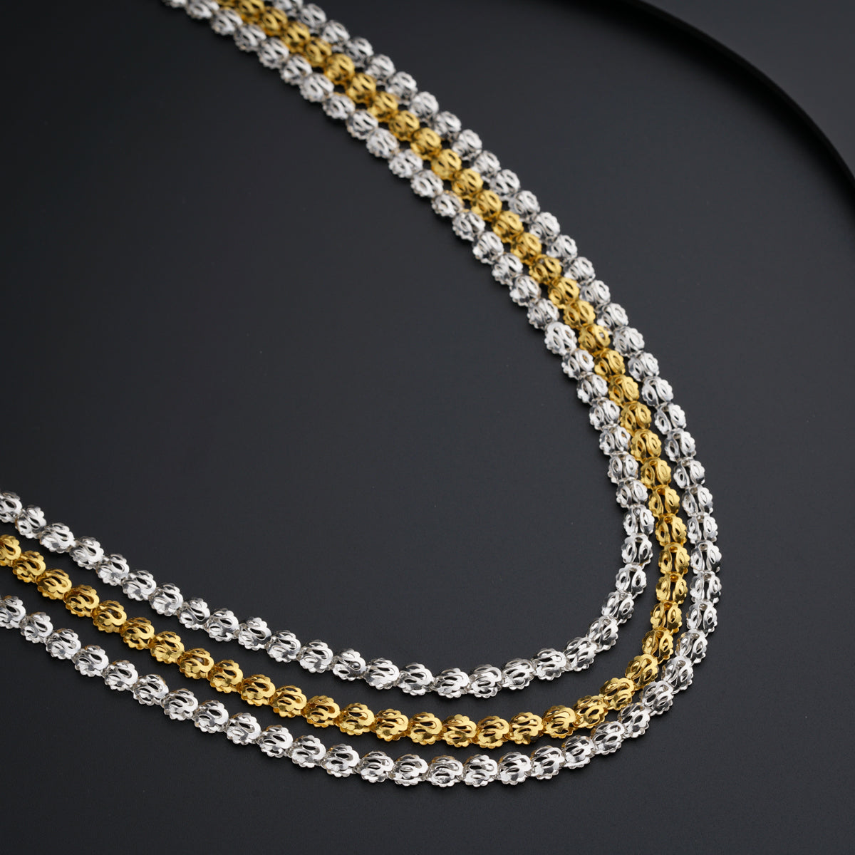 a close up of a chain on a black surface