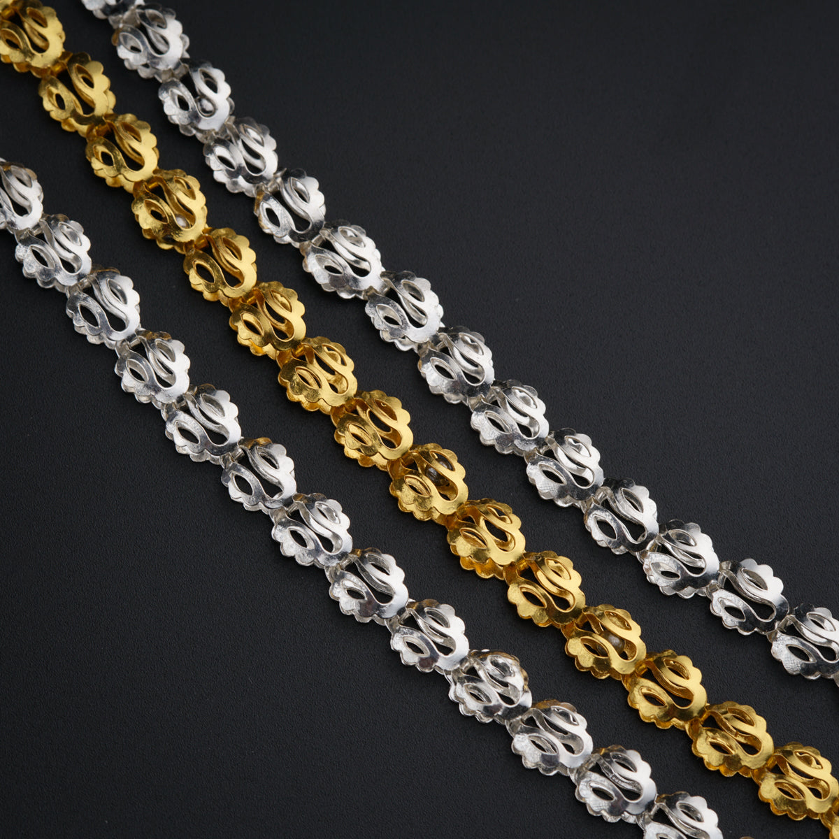 a close up of a chain on a black surface