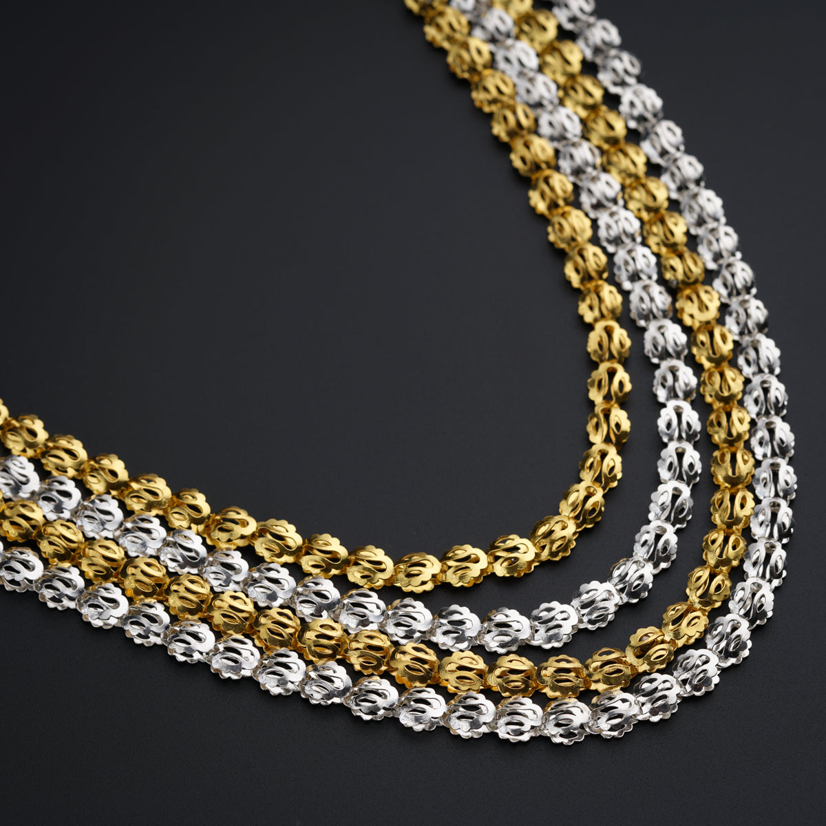 a gold and silver chain on a black background