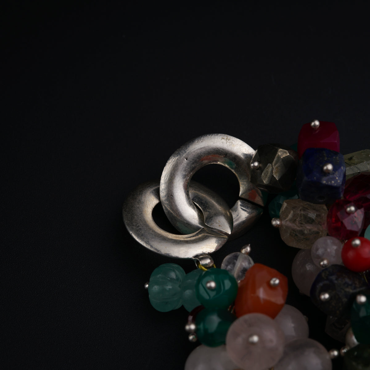 a close up of a bunch of beads on a black surface