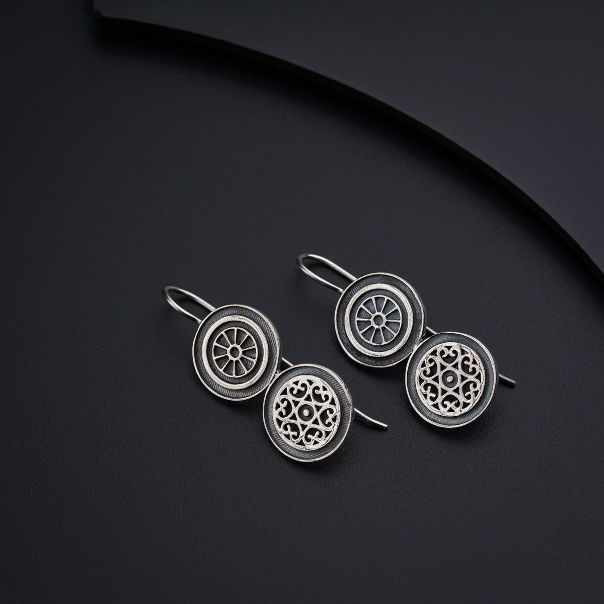 a pair of earrings sitting on top of a table