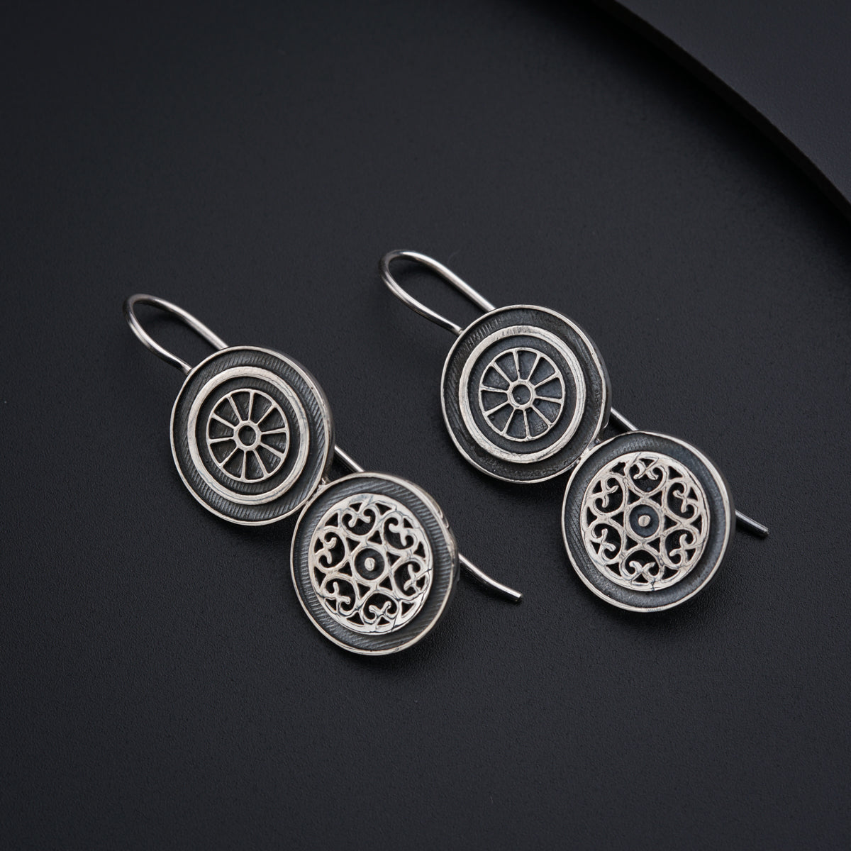 a pair of earrings sitting on top of a table