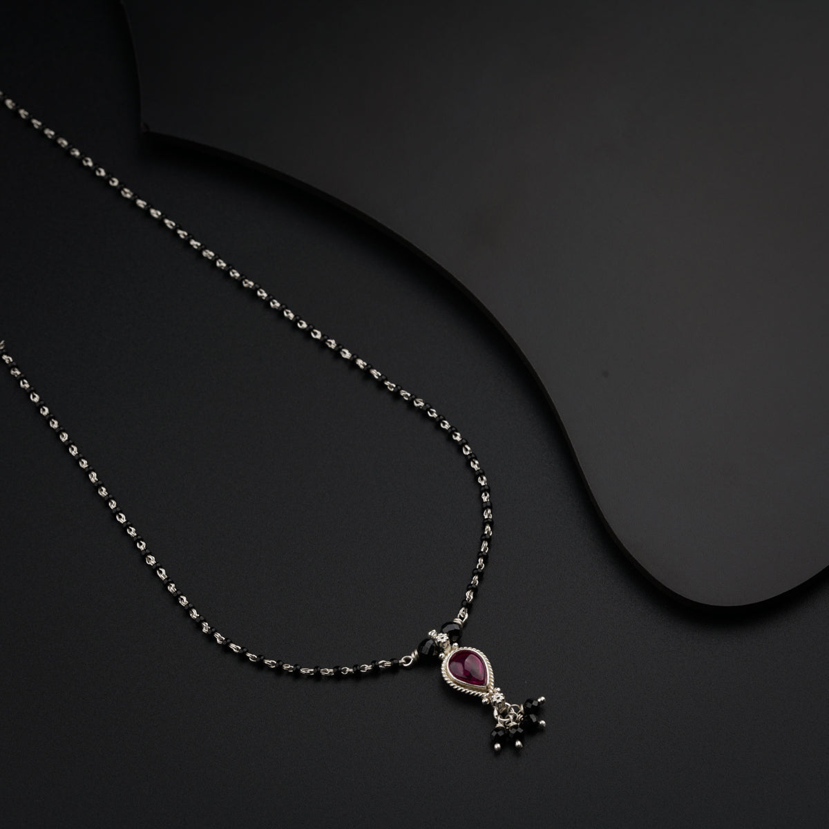 a necklace with a cross and a heart on it