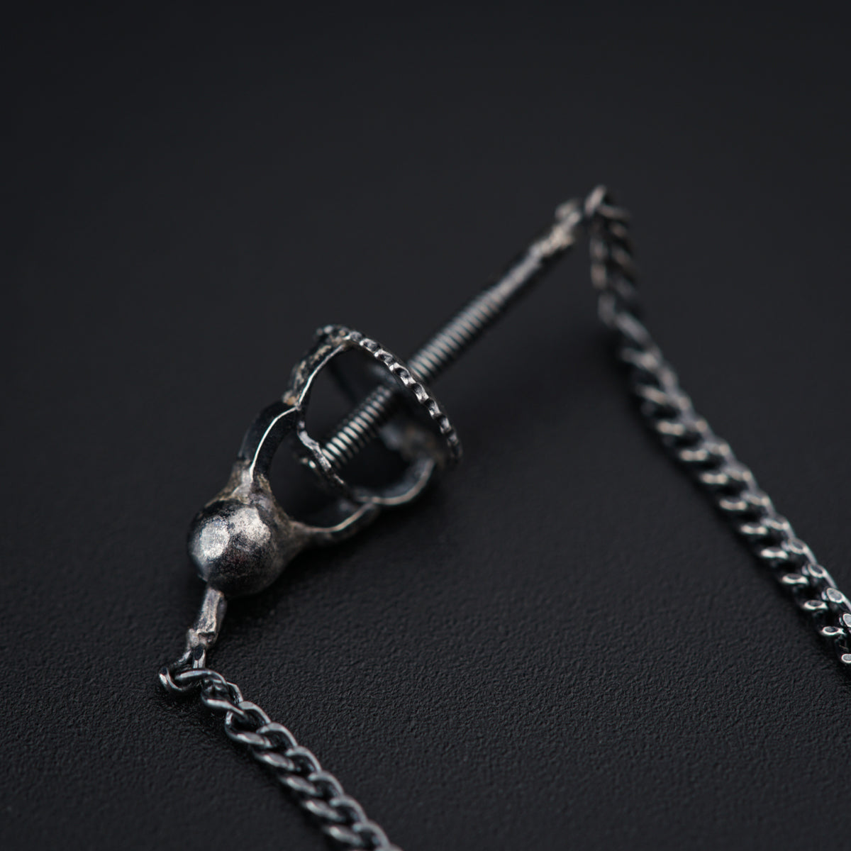 a metal object with a chain attached to it