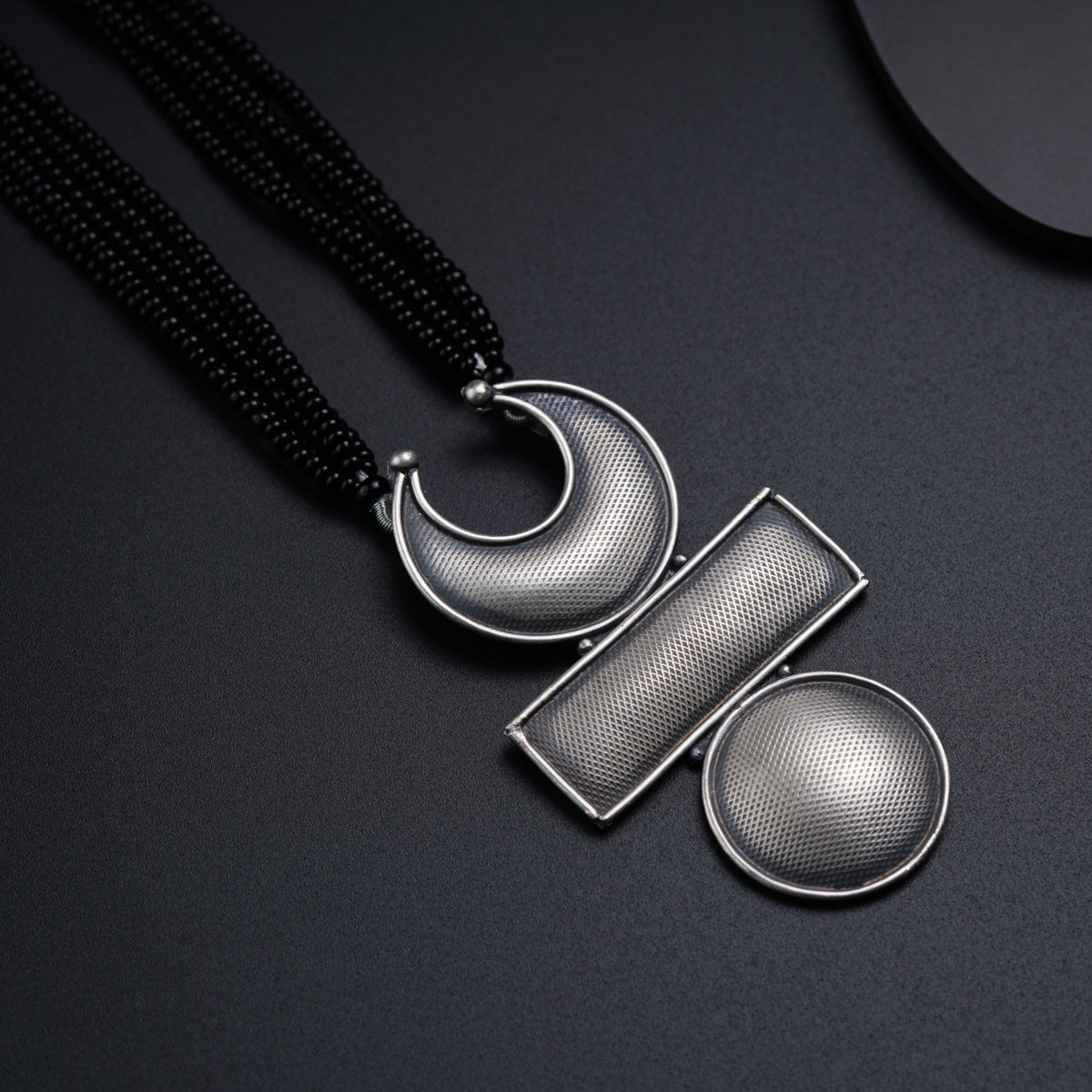 a couple of necklaces sitting on top of a table