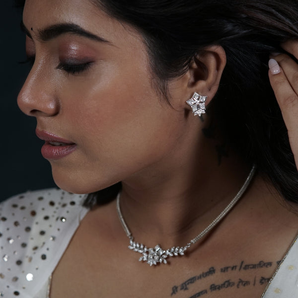 Woman wearing Polki leaf silver jewelry set with necklace and earrings
