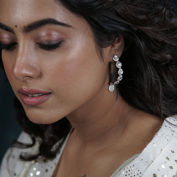 Close-up of woman wearing sparkling moissanite earrings