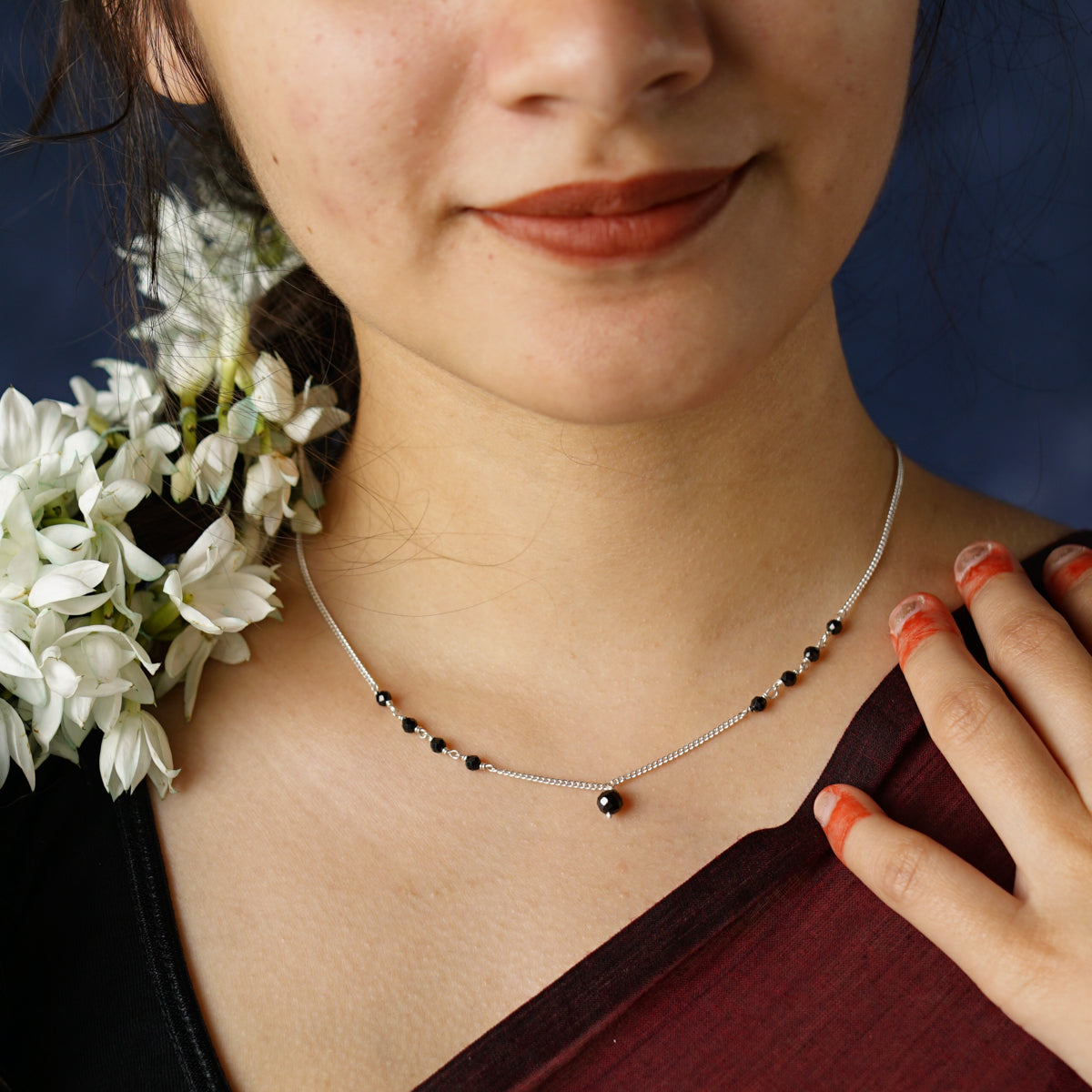 a close up of a person wearing a necklace