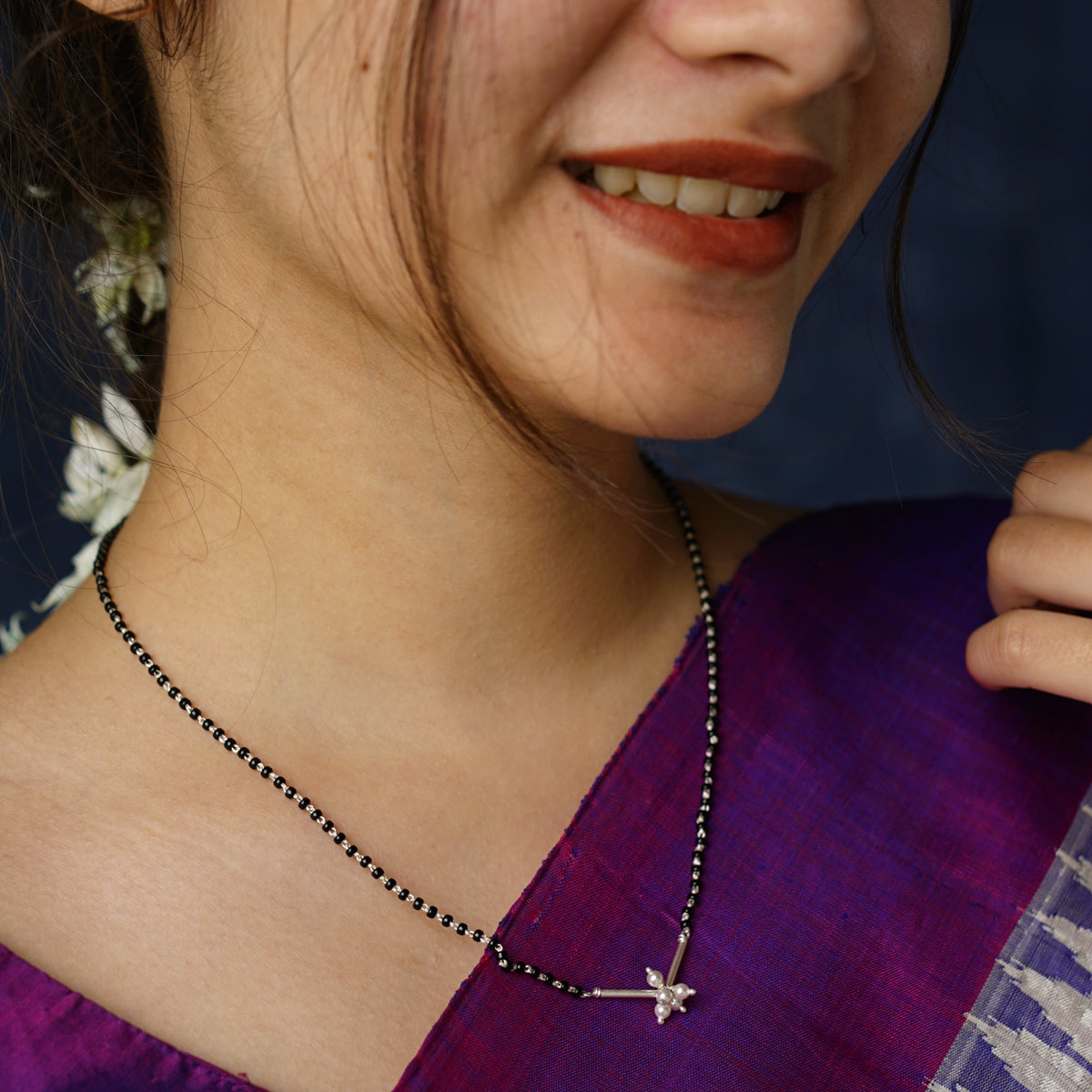 a close up of a person wearing a necklace