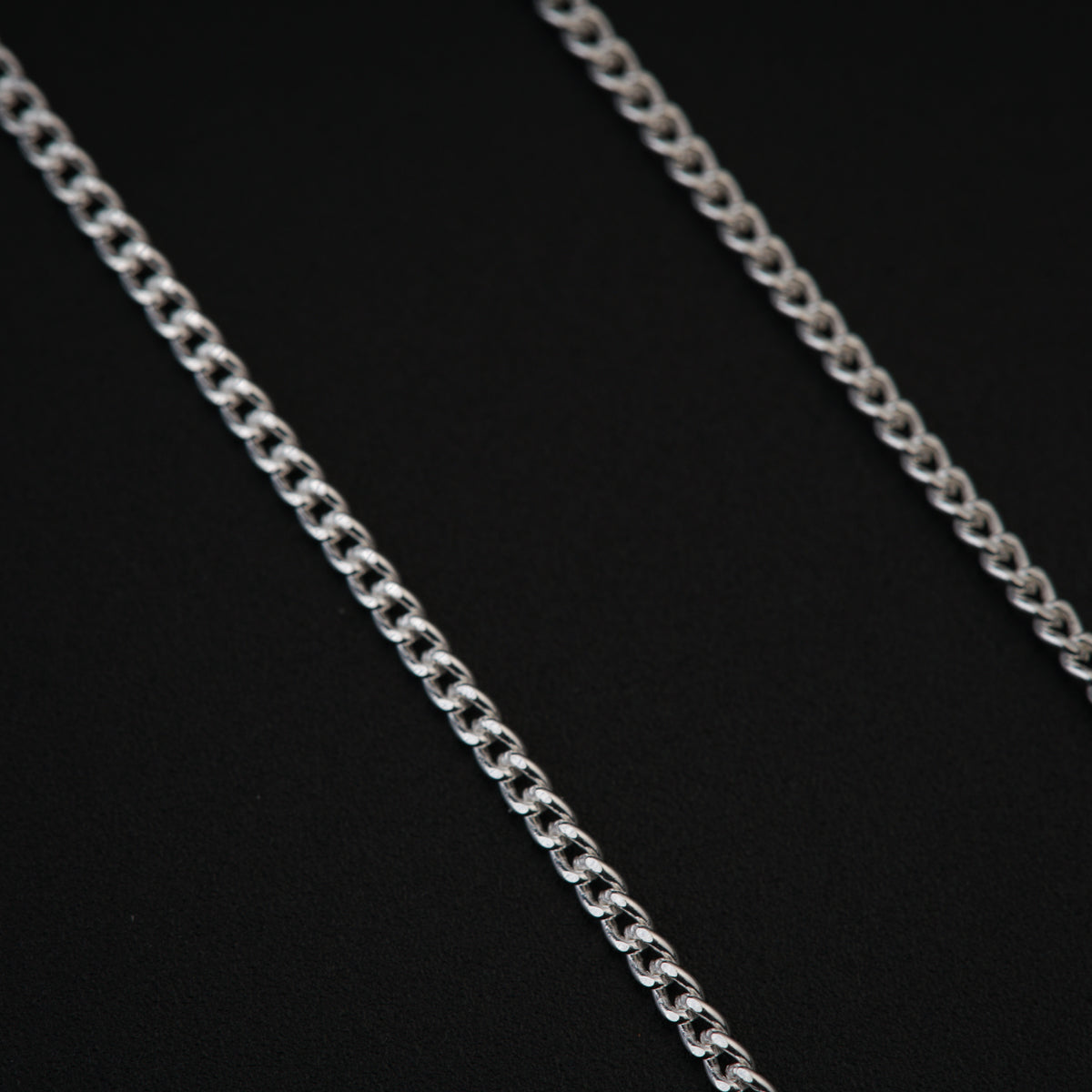 a close up of a chain on a black background