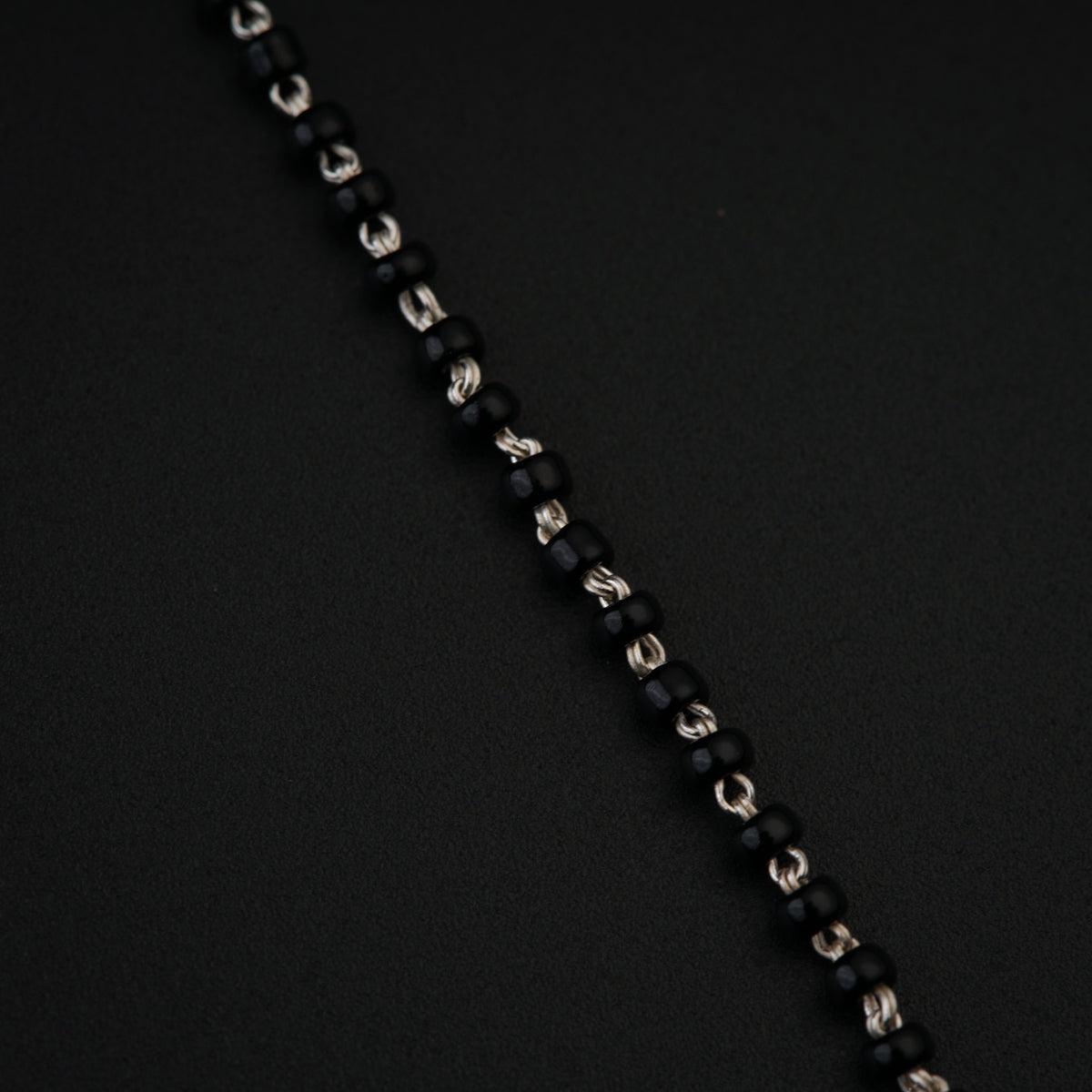 a close up of a chain on a black surface