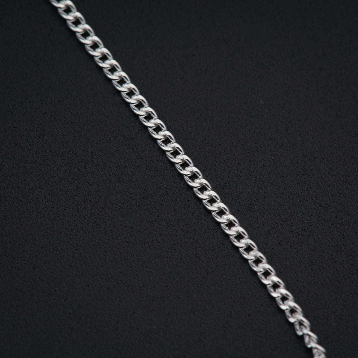 a close up of a chain on a black surface