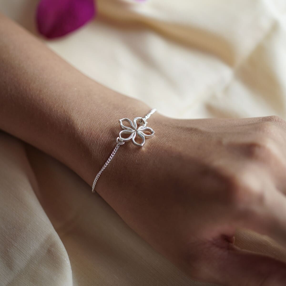 Silver flower bracelet on wrist