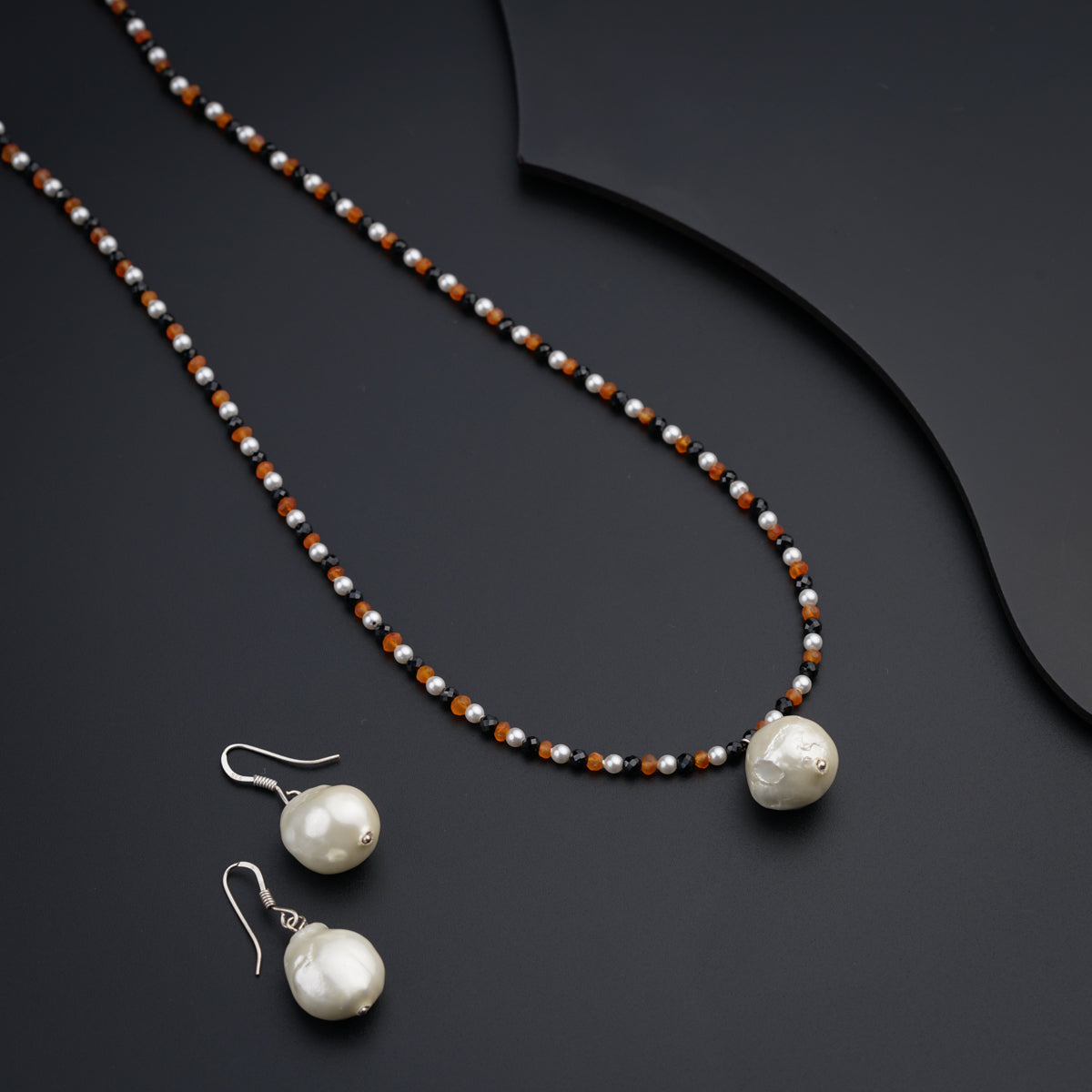 a necklace and earring set with pearls