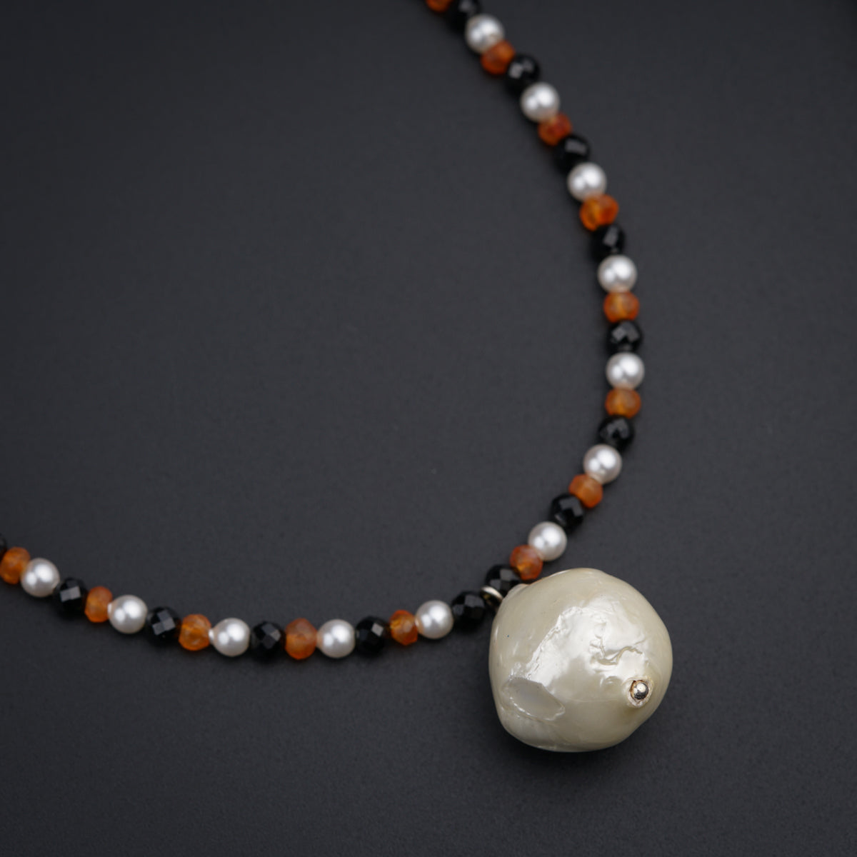 a beaded necklace with a white skull on it