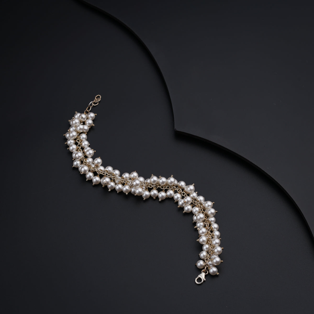 a close up of a necklace on a black surface