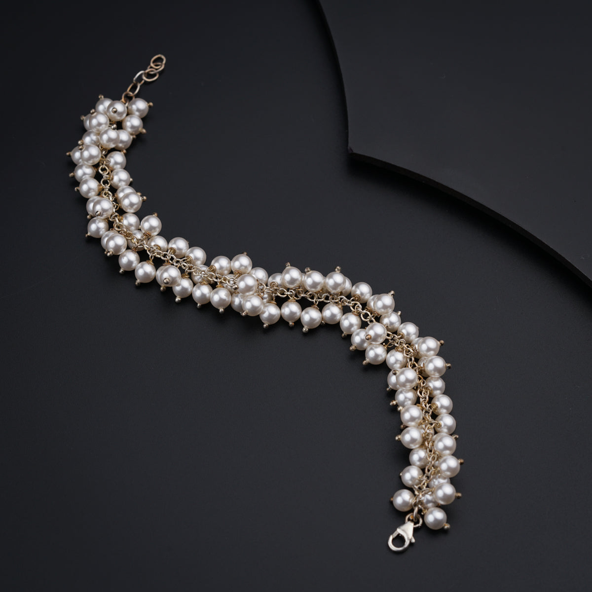 a close up of a necklace on a black surface