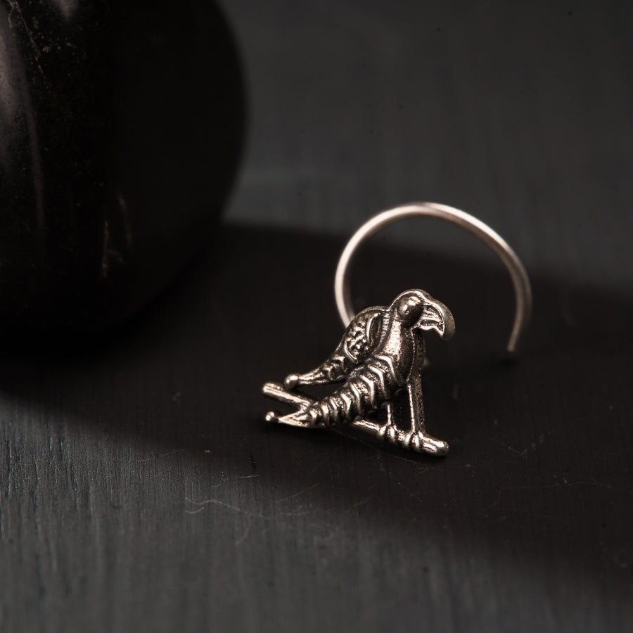 a silver ring with a skeleton sitting on top of it