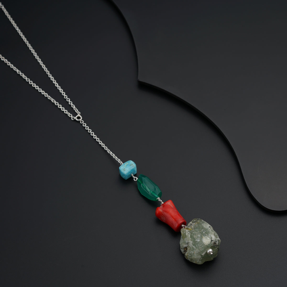 a necklace with a rock and a bead on it