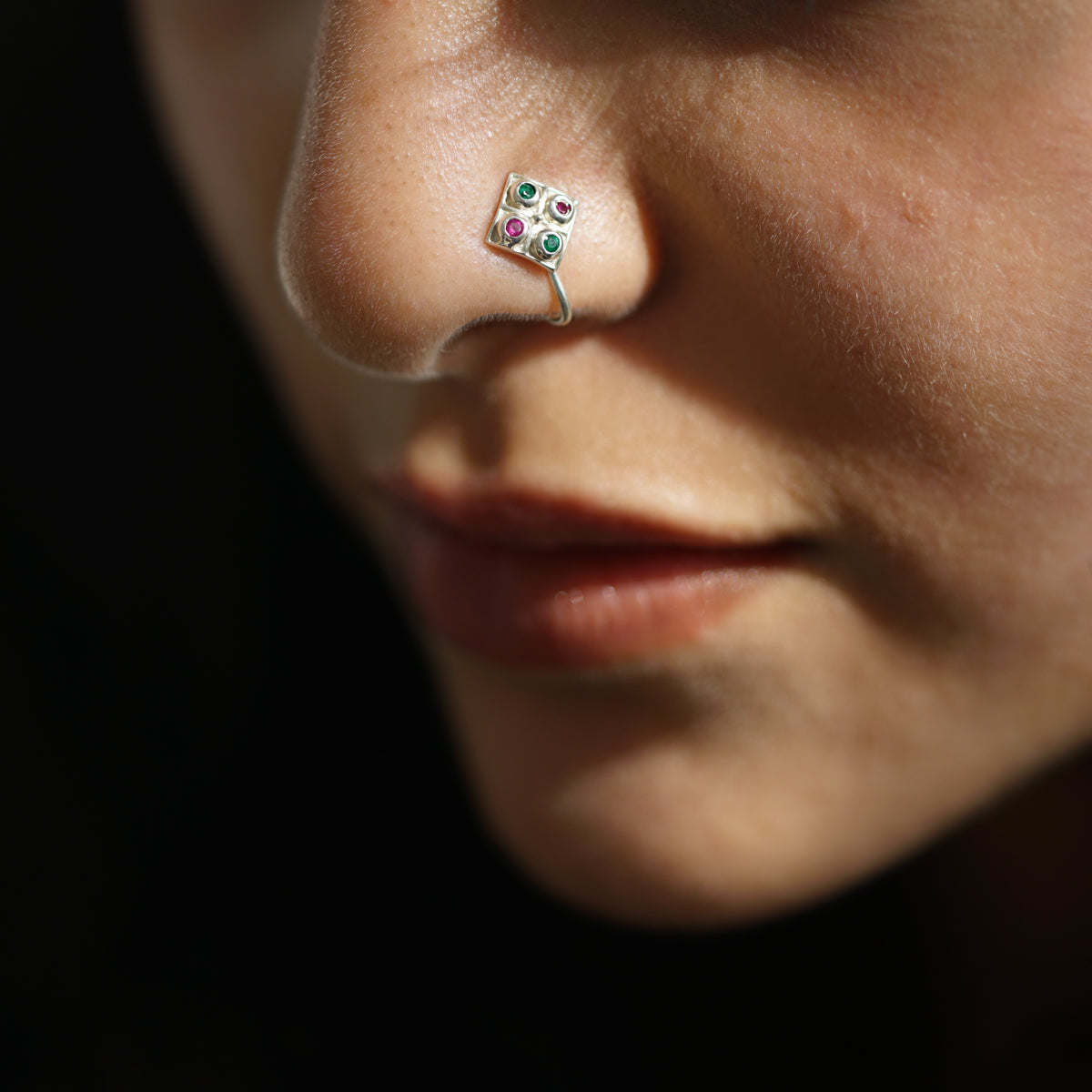 a close up of a person with a nose piercing