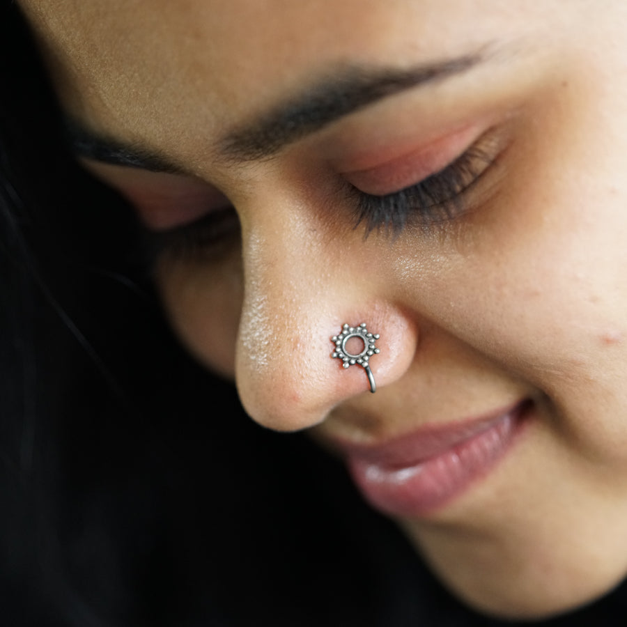 a close up of a person with a nose piercing
