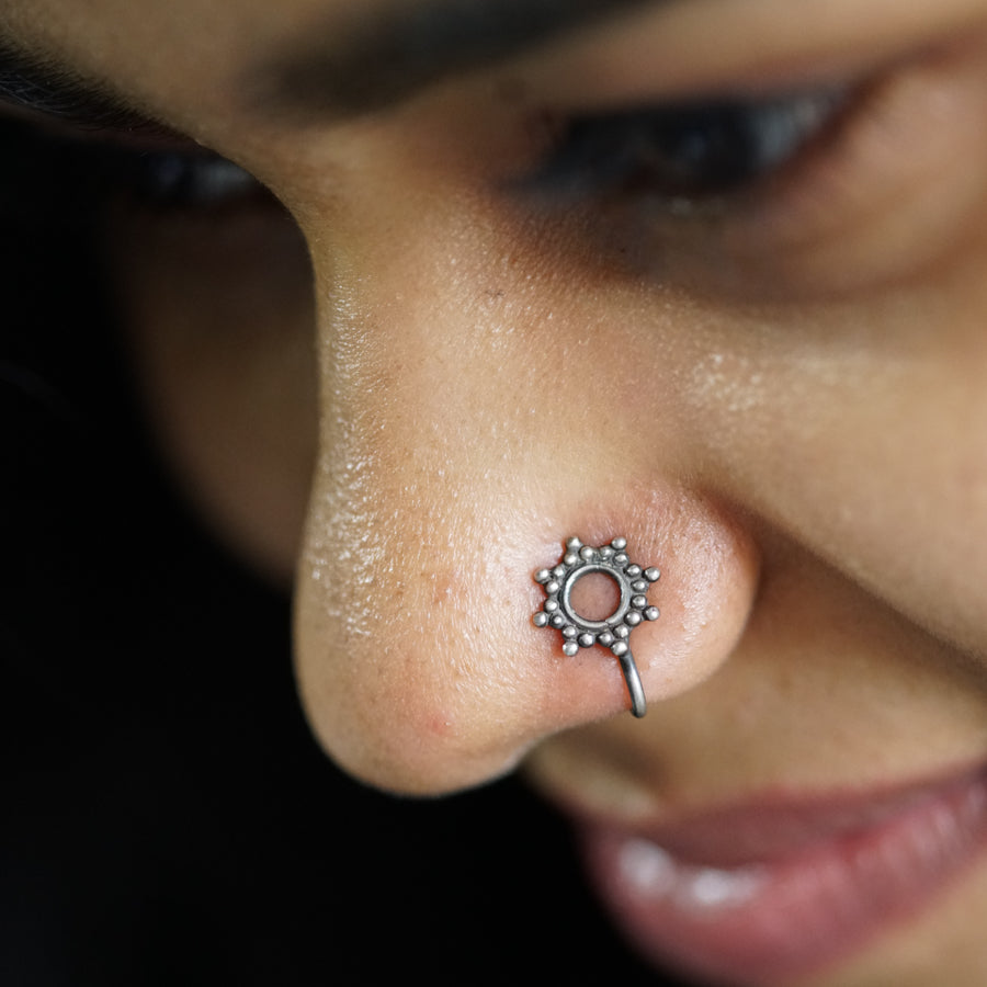 a close up of a person with a nose piercing