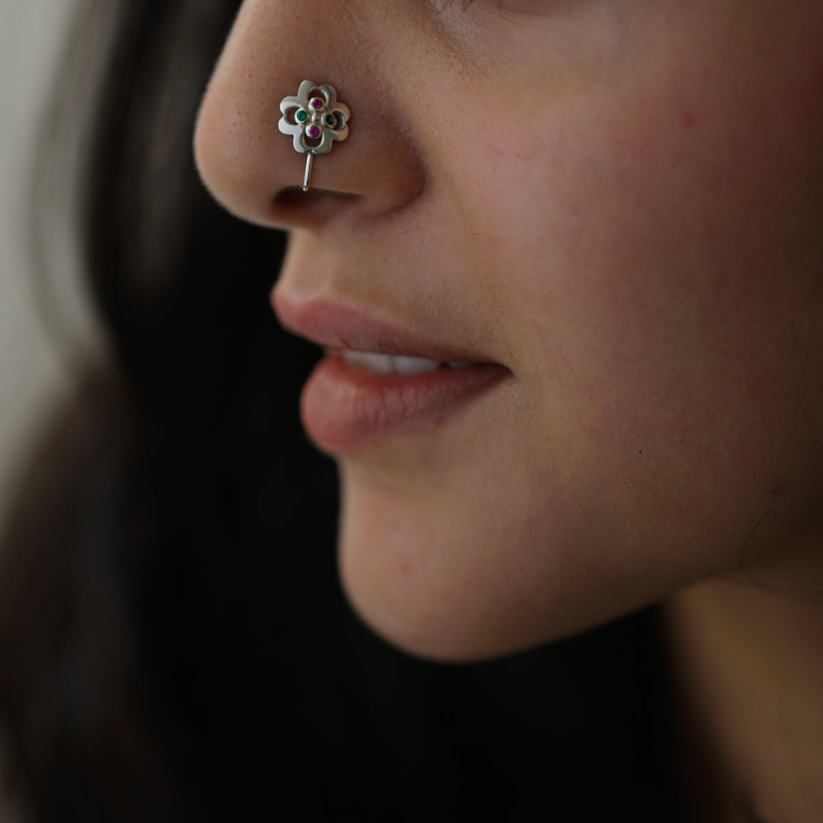 a close up of a person with a nose piercing