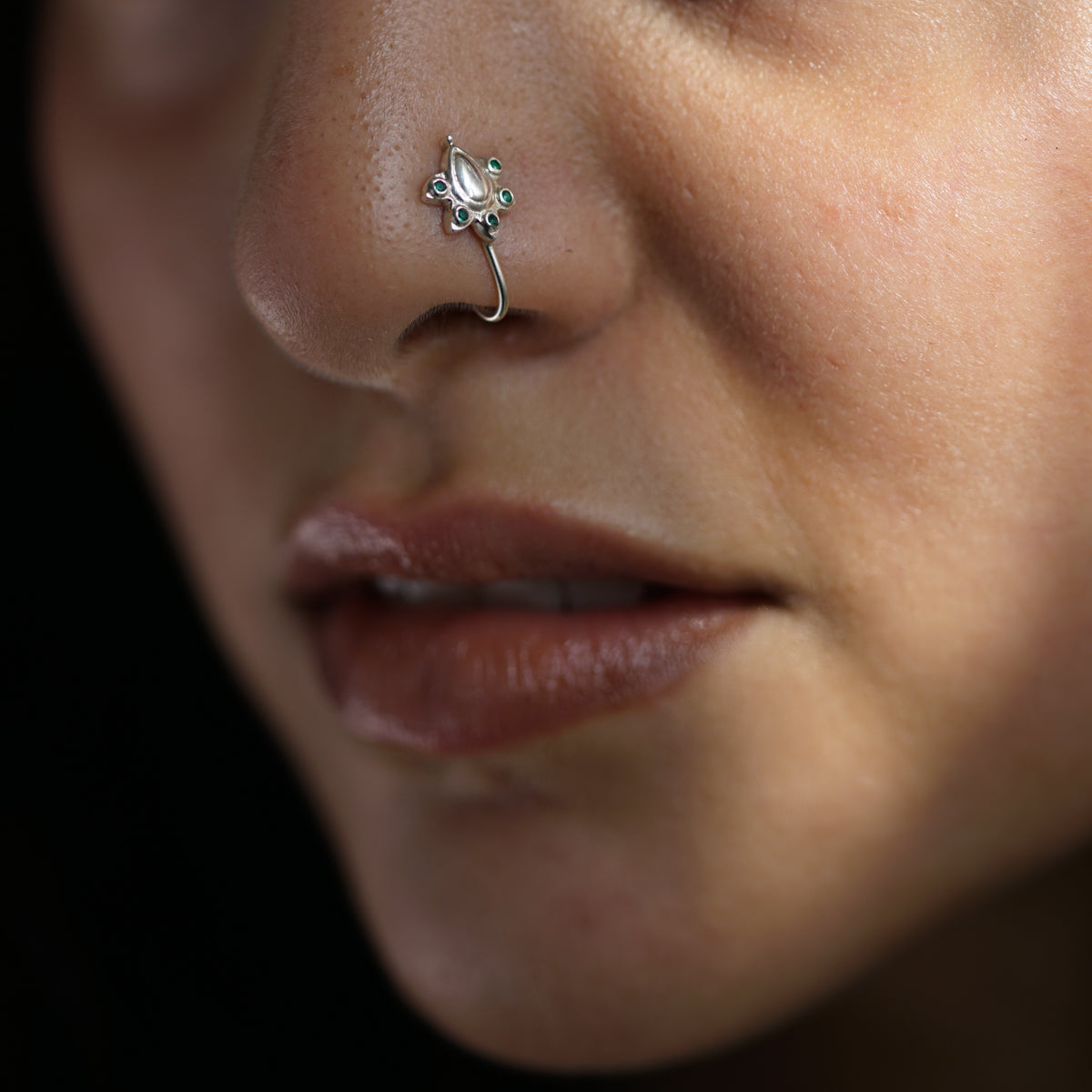 a close up of a person with a nose piercing