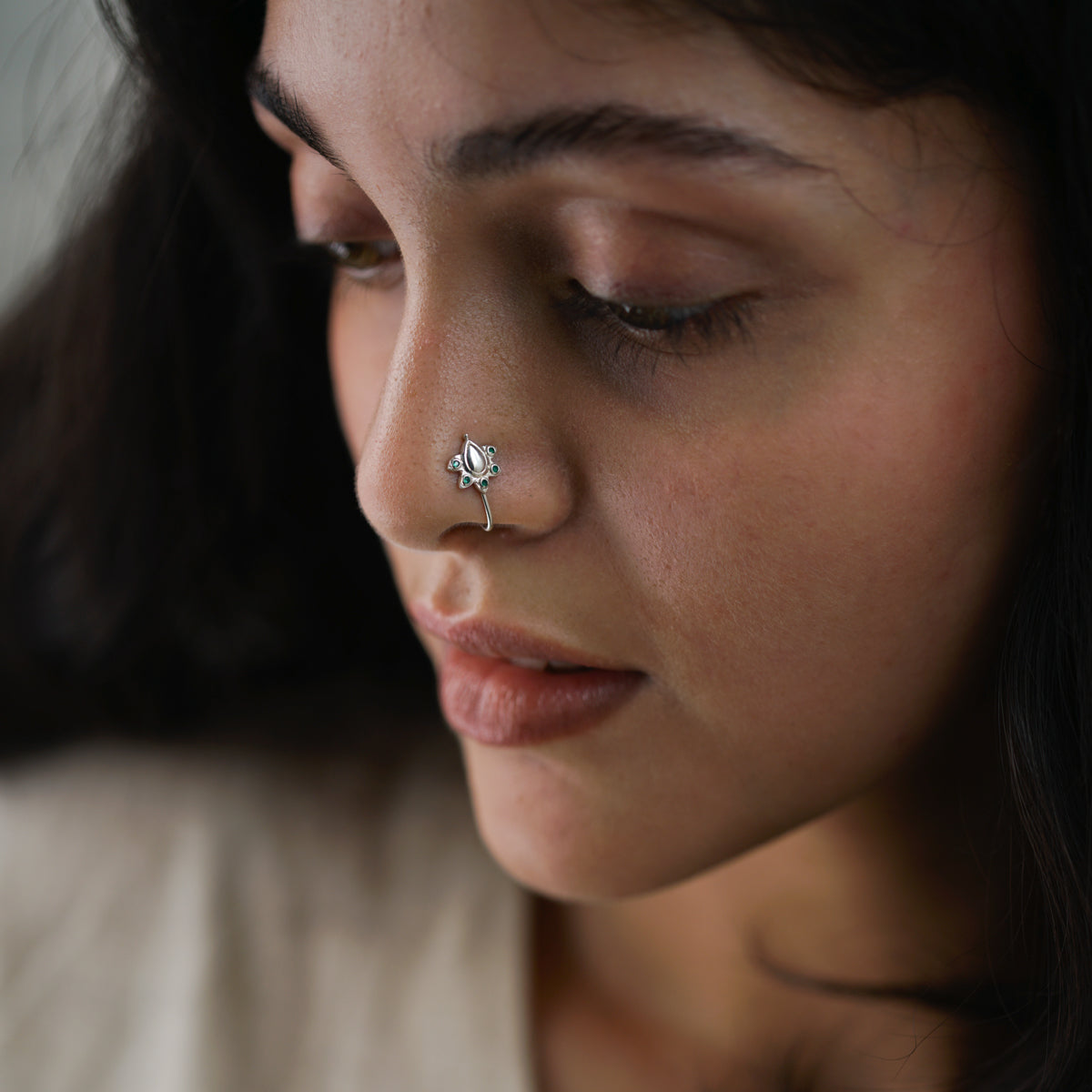 a woman with a nose piercing on her nose