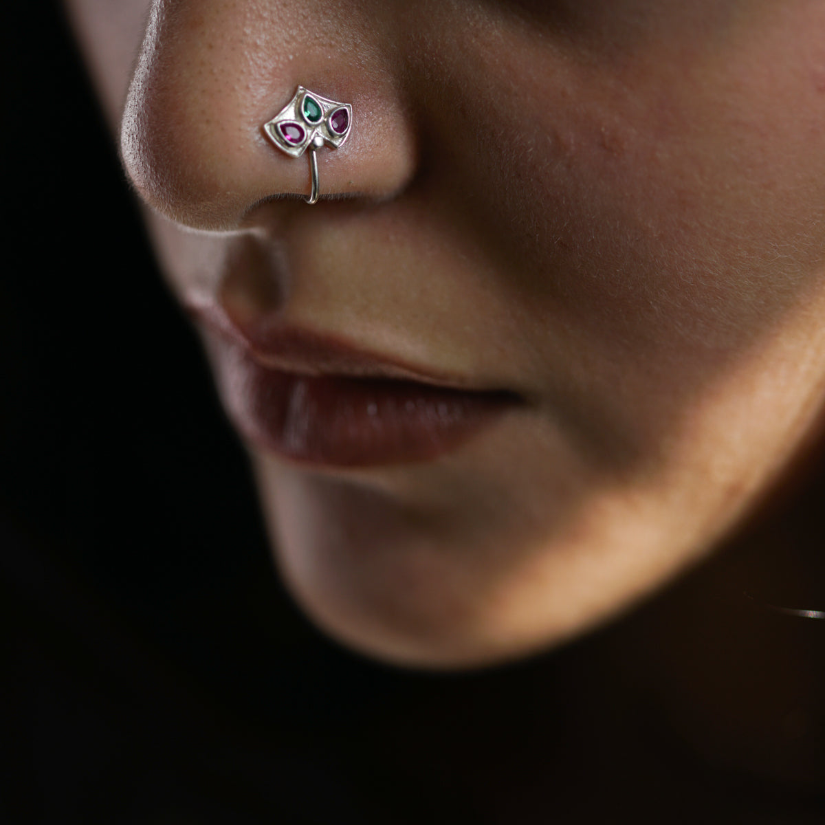 a close up of a person with a nose piercing