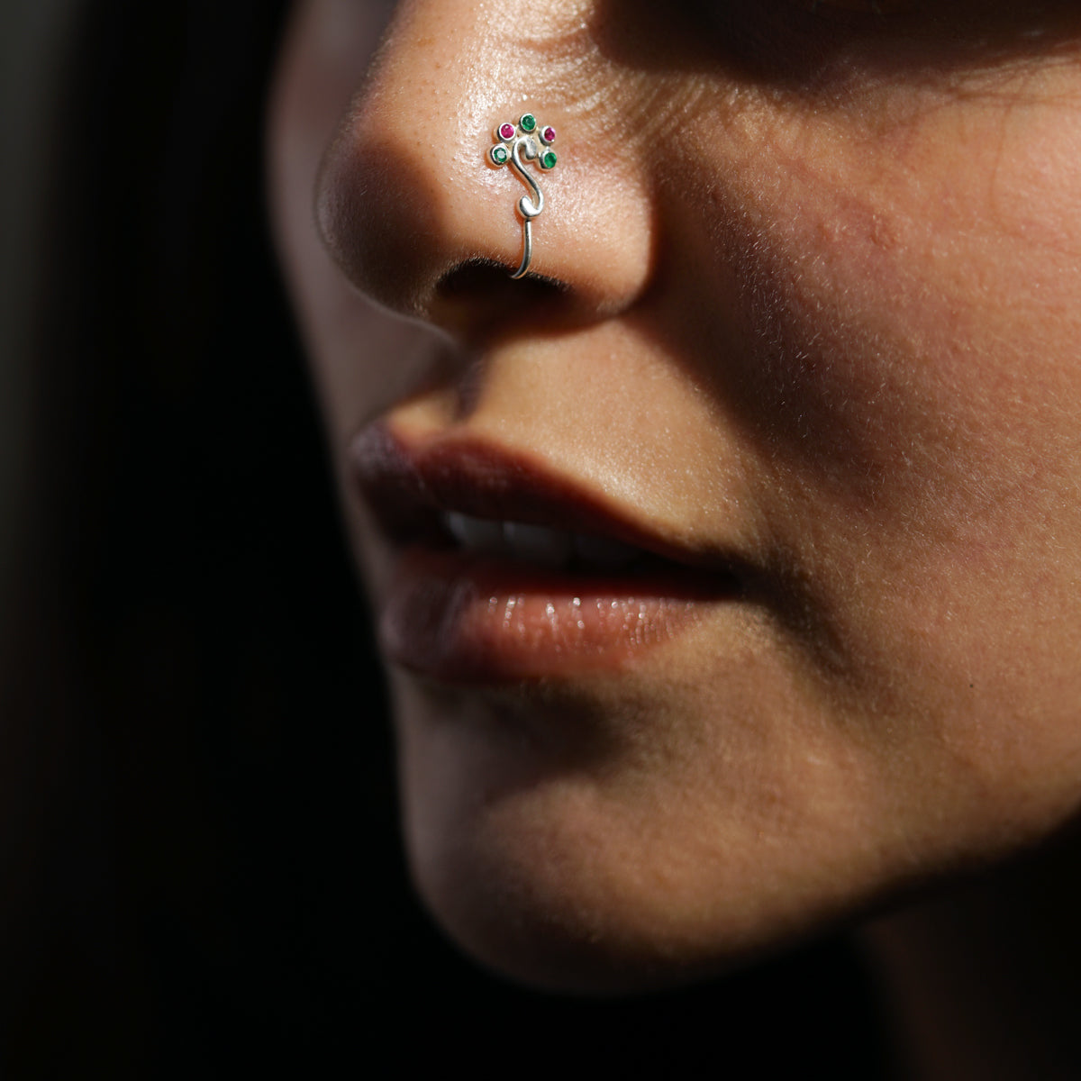 a close up of a person with a nose piercing