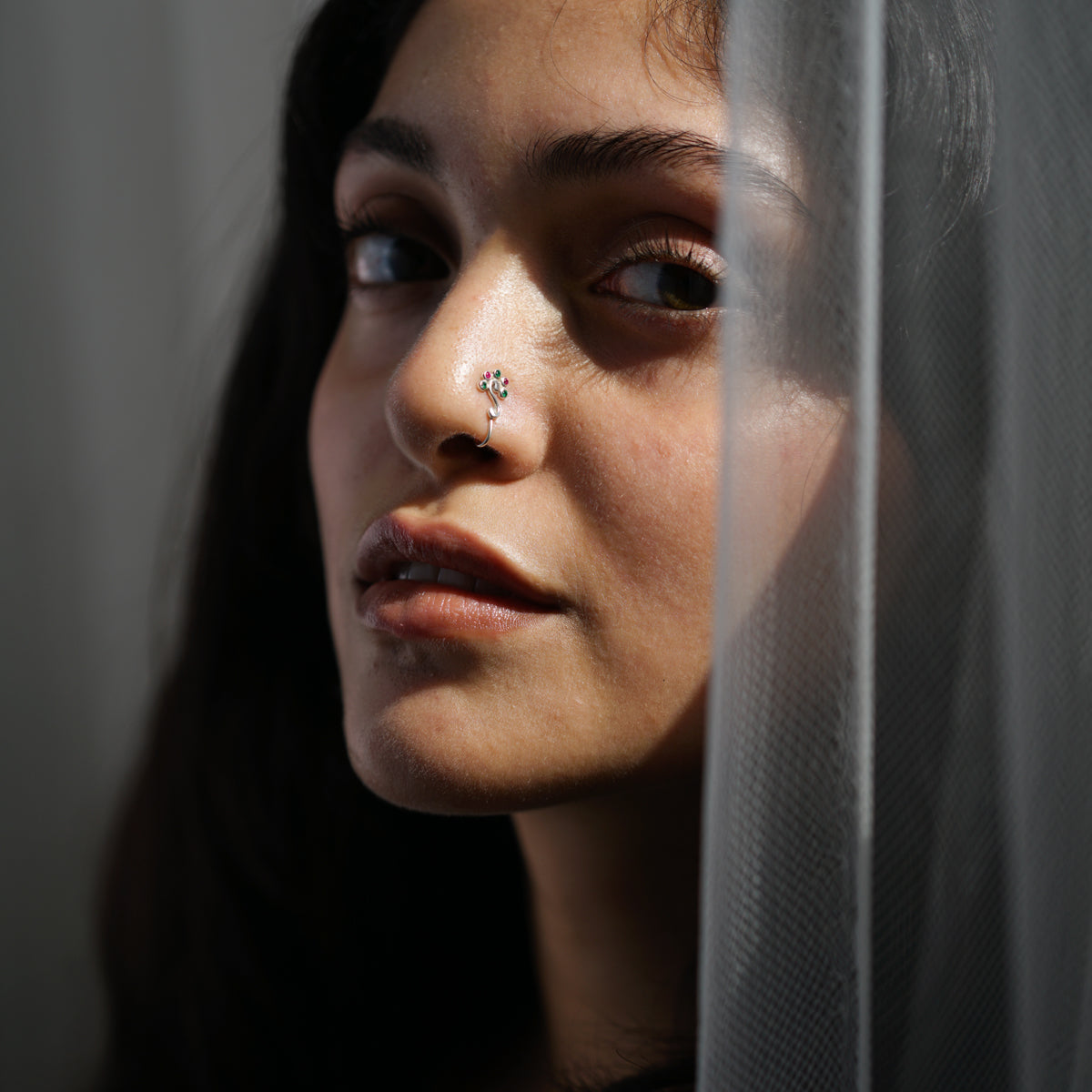 a close up of a person with a nose piercing