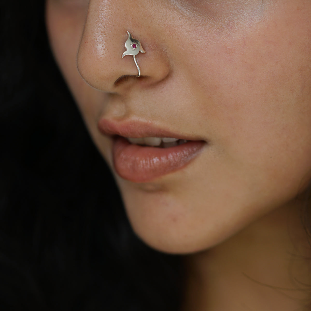 a close up of a person with a nose piercing