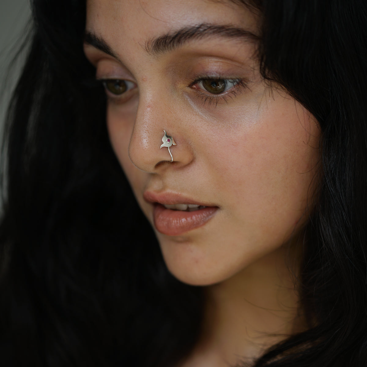 a close up of a person with a nose piercing