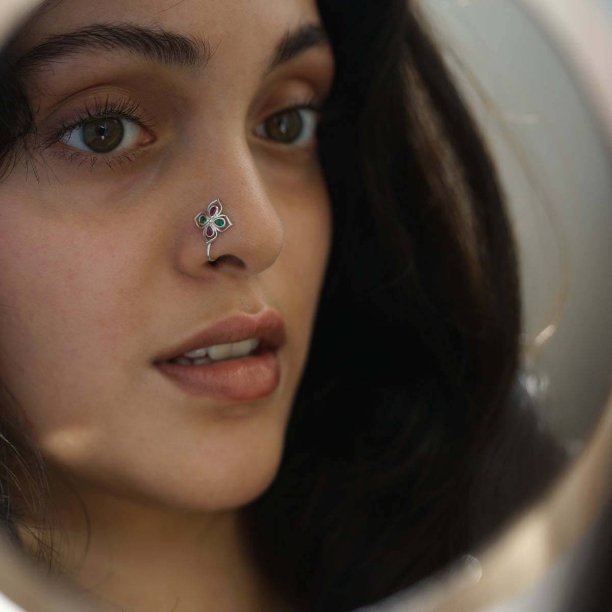 a close up of a person with a nose piercing