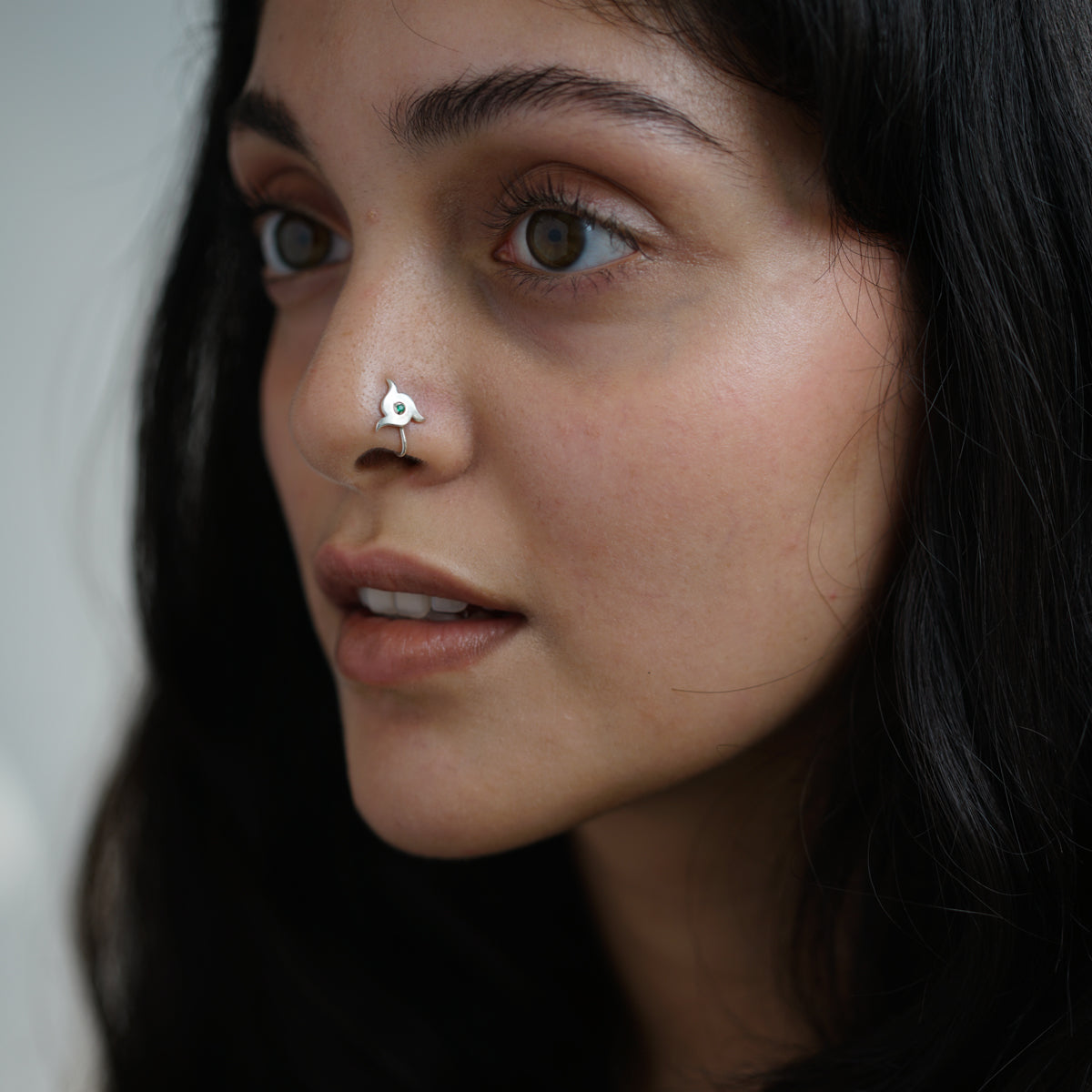a woman with a nose piercing on her nose
