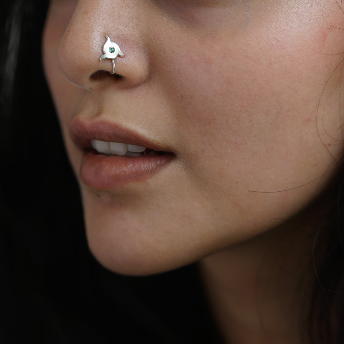 a close up of a person with a nose piercing