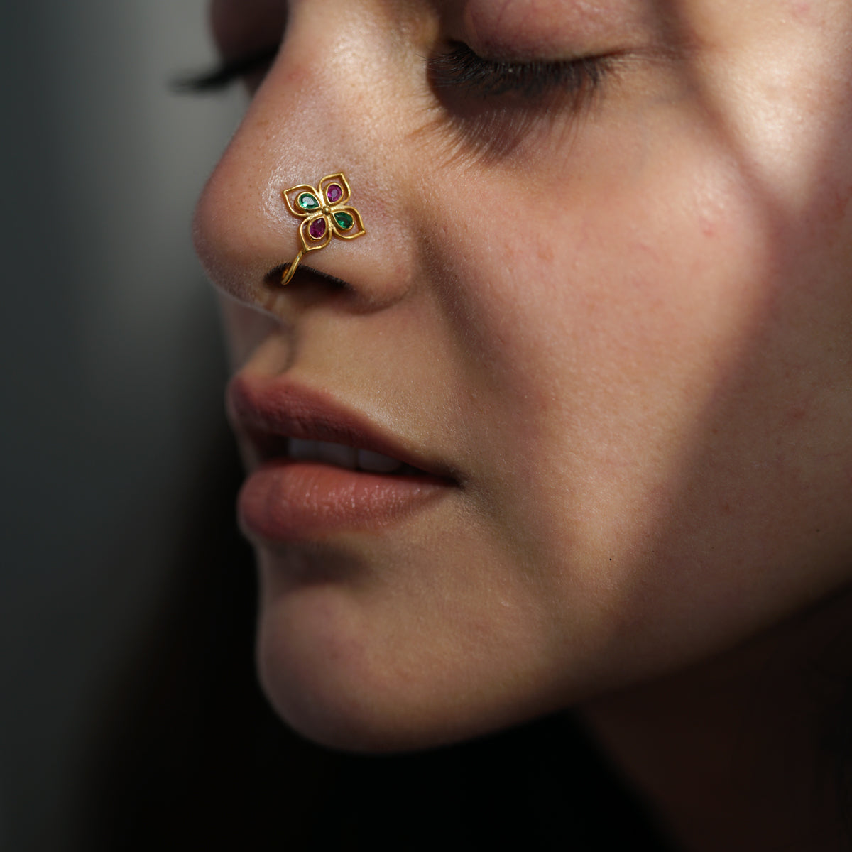 a close up of a person with a nose piercing