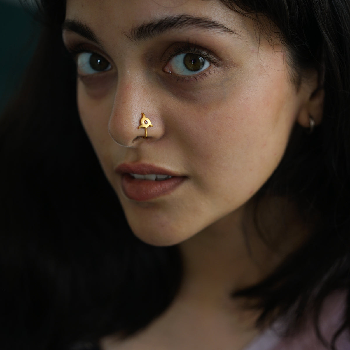 a woman with a nose piercing on her nose