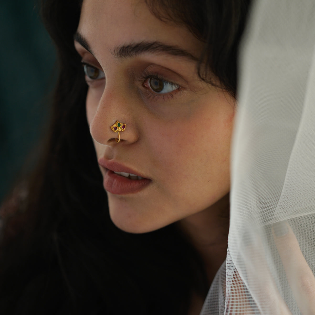 a woman with a nose piercing on her nose