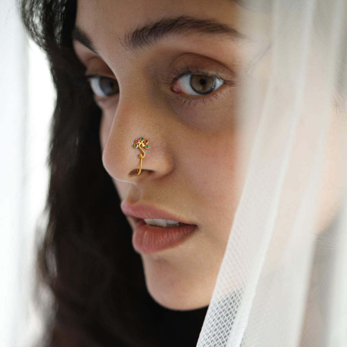 a close up of a person with a nose piercing