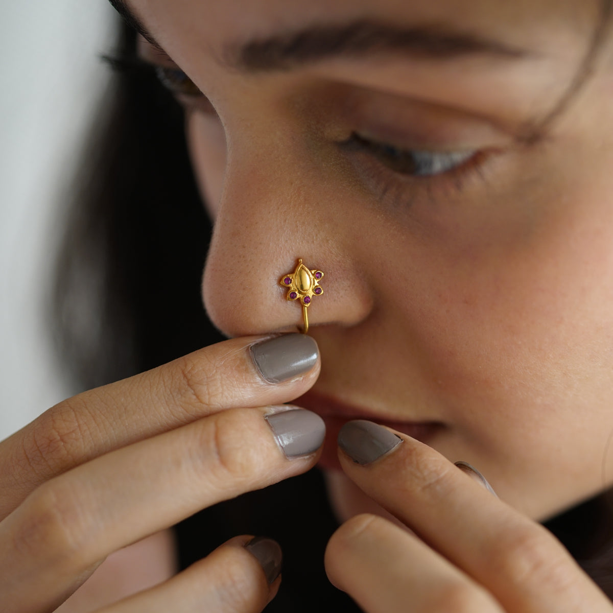 a woman with a nose piercing on her nose
