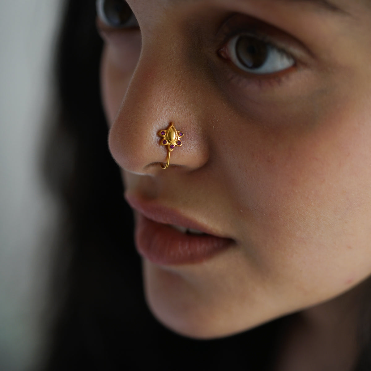 a close up of a person with a nose piercing